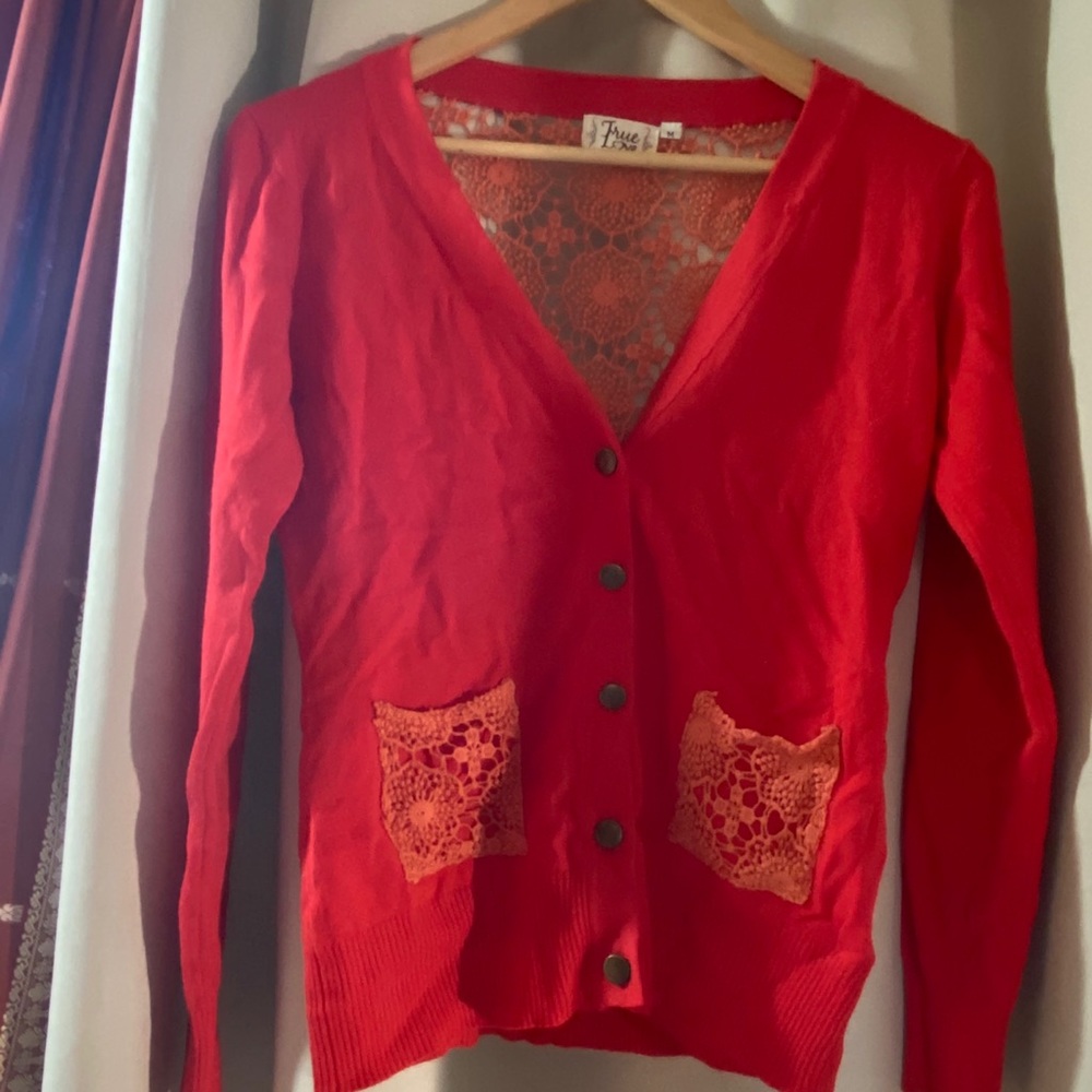 Bright red button up sweater with lace